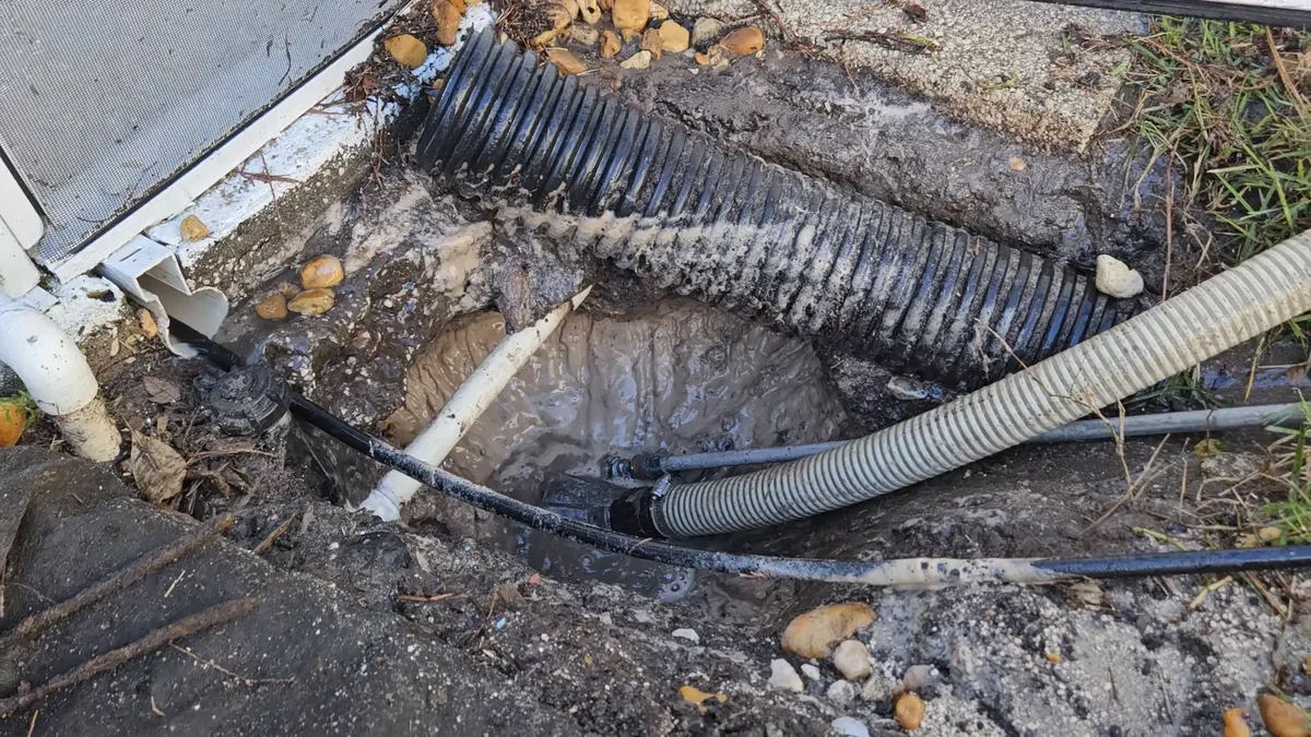Using a pressure washer sludge sucker to rapidly evacuate standing water in Land O' Lakes, Florida