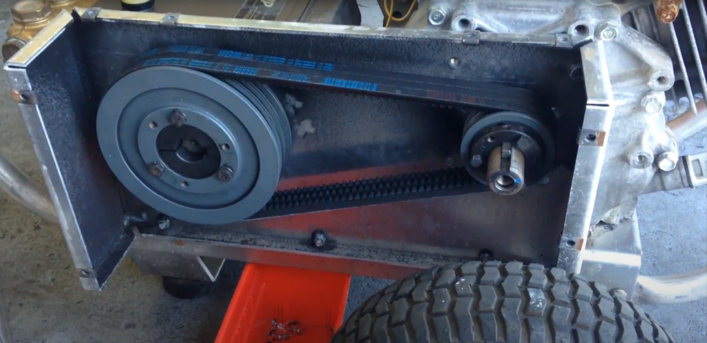 showing the belt and pully system of a belt-driven pressure washer